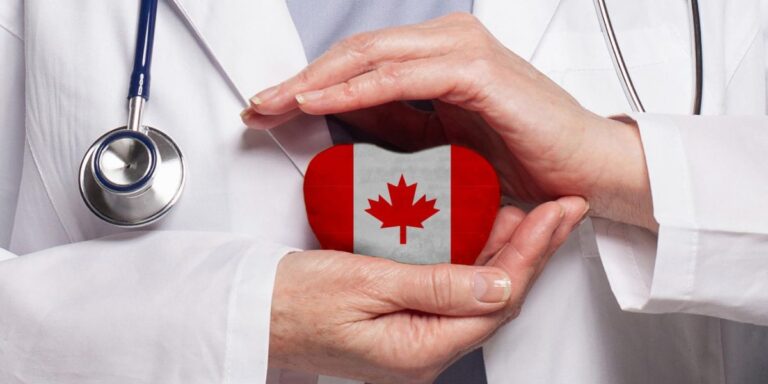 Hands in a white lab coat cup a heart-shaped object decorated with the Canadian flag